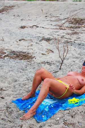 Woman Sunbathes Nude After Taking Off Yellow Bikini — photo 18